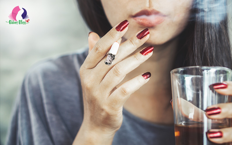 Image of a woman drinking alcohol and smoking
